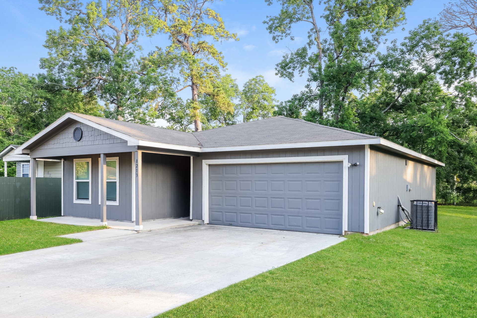 8213 Linda Vista Road Houston, TX 77028 - Photo 2 of 21 a front view of a house with a garden and garage
