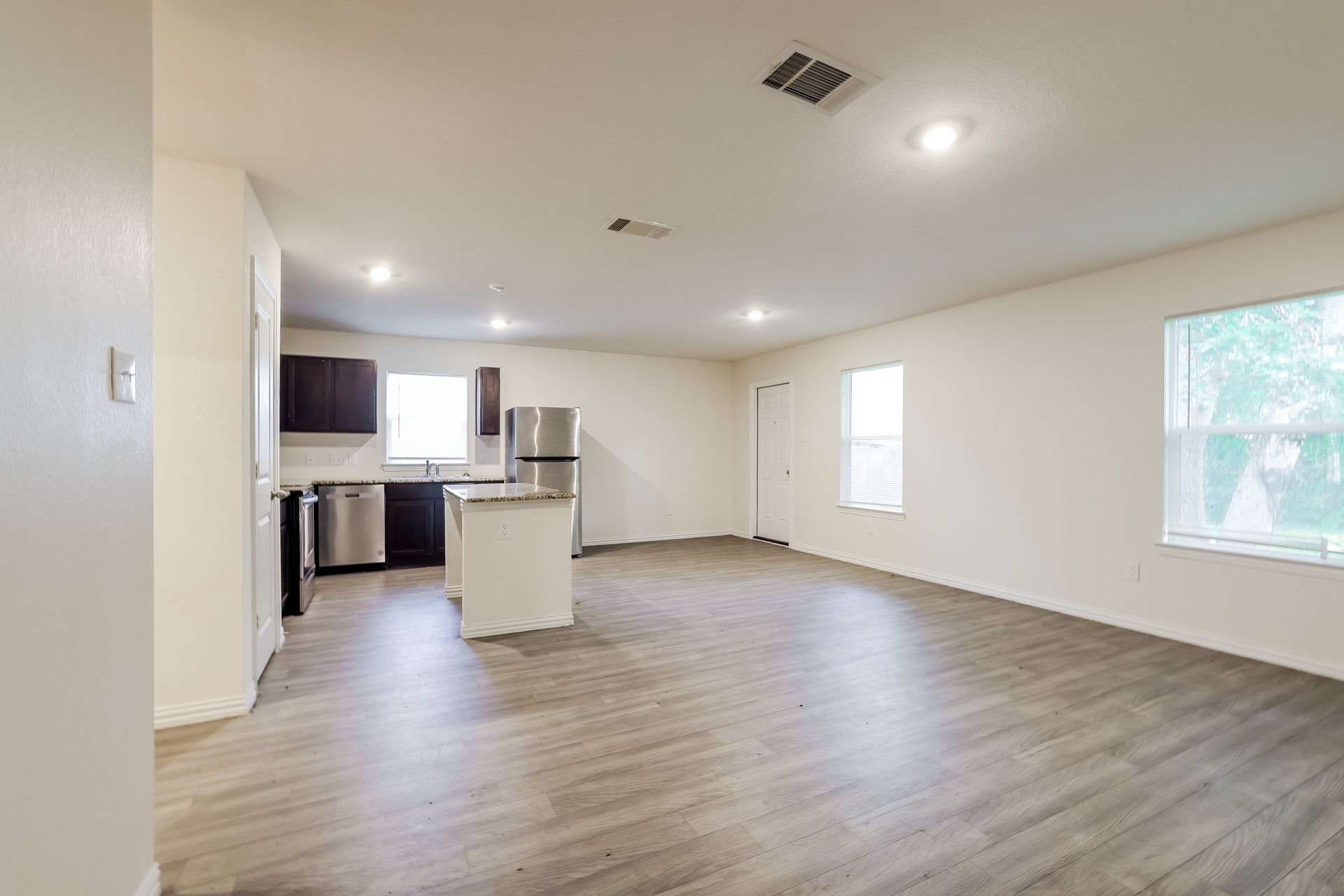 8213 Linda Vista Road Houston, TX 77028 - Photo 3 of 21 an empty room with wooden floor and windows