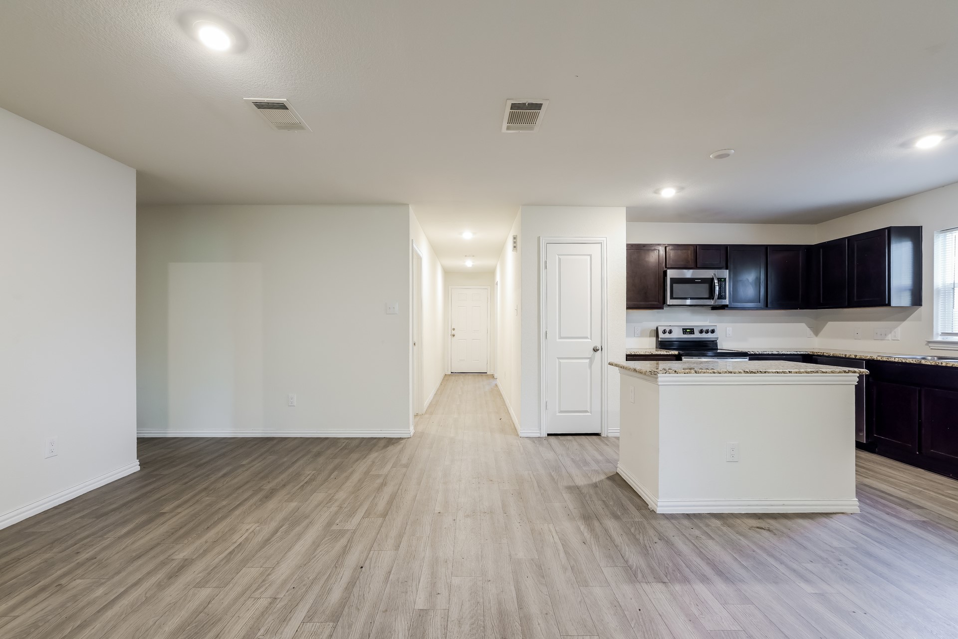 8213 Linda Vista Road Houston, TX 77028 - Photo 4 of 21 a view of kitchen with wooden floor and electronic appliances