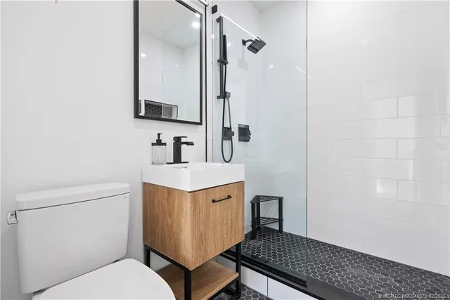 a bathroom with a sink toilet and shower