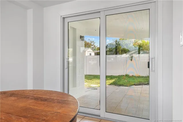 a view of a glass door with a tree in front of it