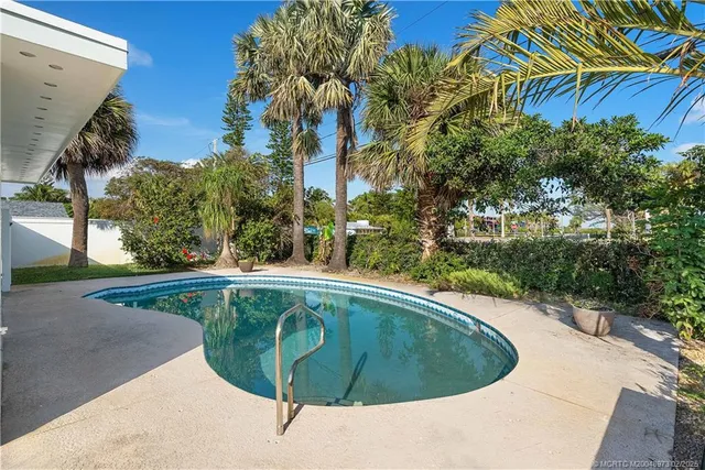 a view of a swimming pool with a patio