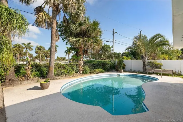 a view of a swimming pool with an outdoor space and seating area