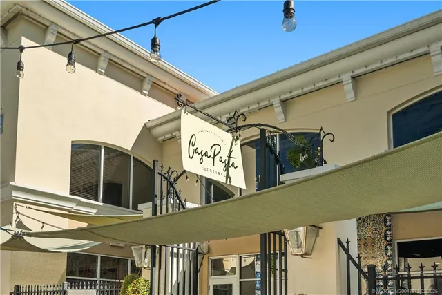 a view of swimming pool with outdoor seating and plants