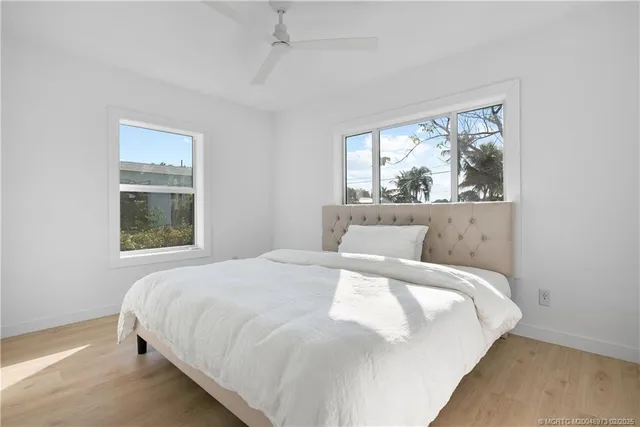 a large bed sitting in a bedroom next to a window