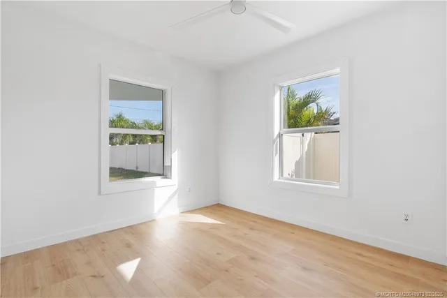 an empty room with windows and closet