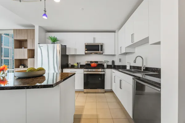 a kitchen with a sink stove and refrigerator