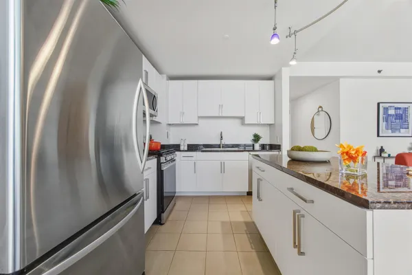a kitchen with refrigerator and cabinets