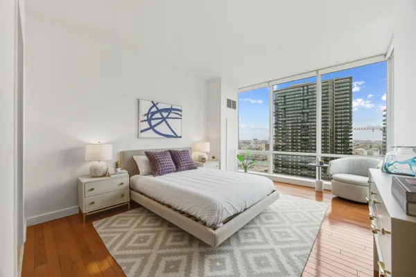 a bedroom with a large bed and a large window
