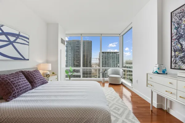 a bedroom with a large bed and a large window