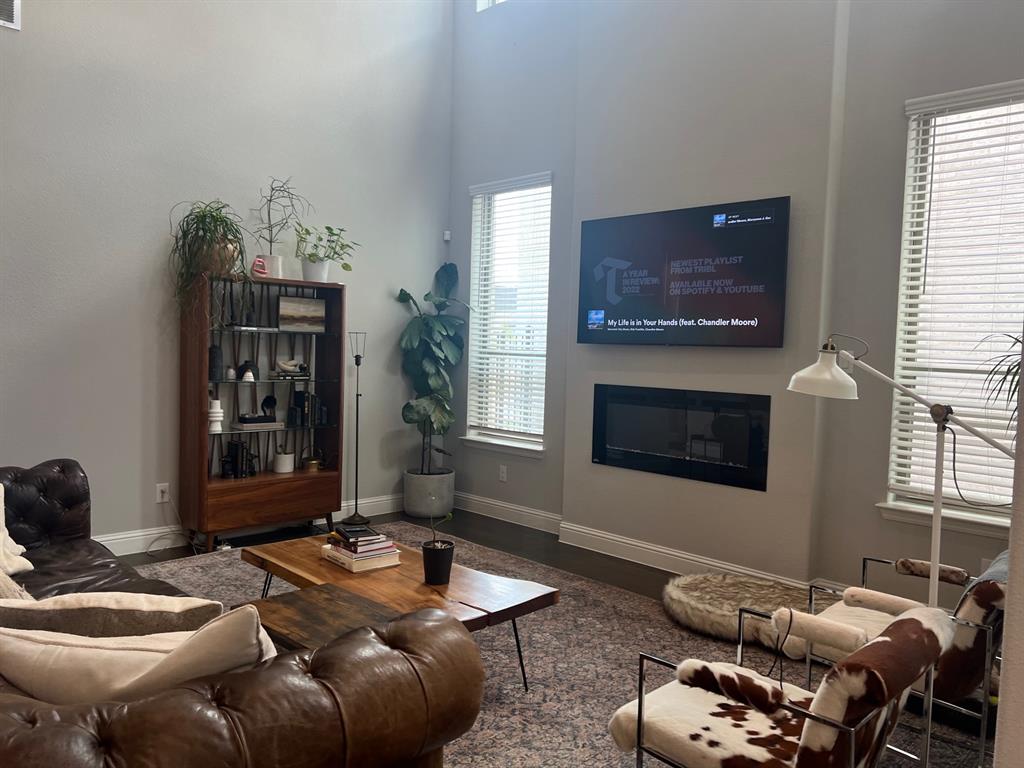 13244 Jonata Street Frisco, TX 75035 - Photo 11 of 20 a living room with furniture a flat screen tv and a fireplace