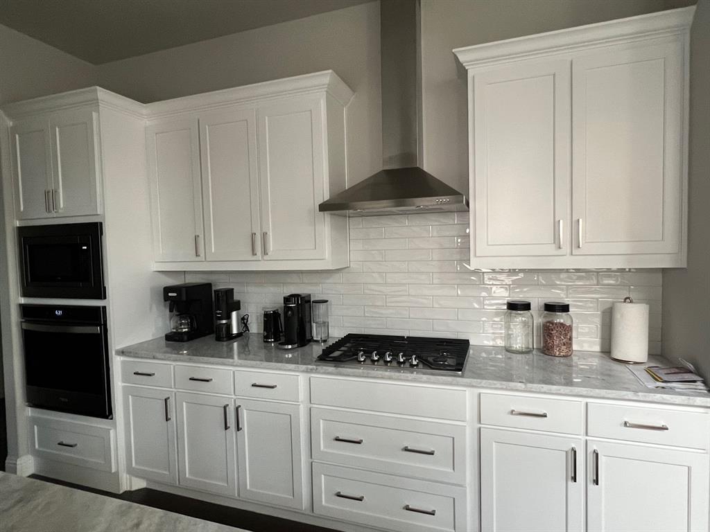 13244 Jonata Street Frisco, TX 75035 - Photo 4 of 20 a kitchen with white cabinets and white appliances