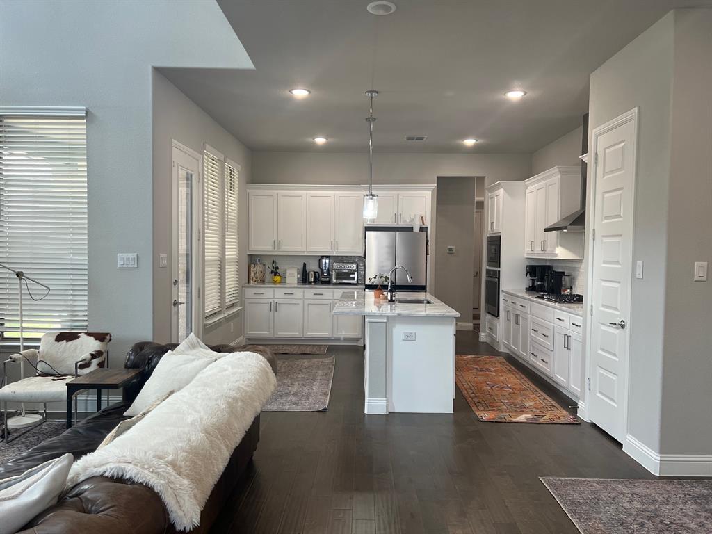 13244 Jonata Street Frisco, TX 75035 - Photo 6 of 20 a large living room with stainless steel appliances kitchen island granite countertop a couch and a view of living room