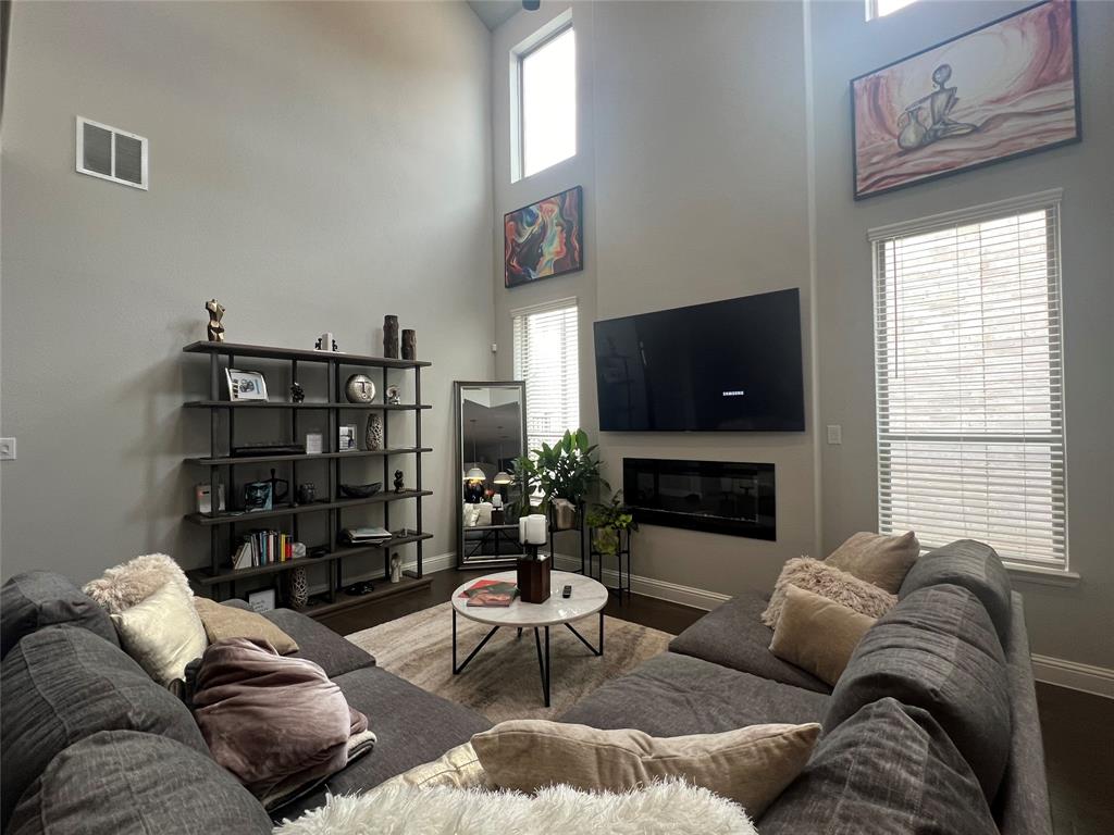 13244 Jonata Street Frisco, TX 75035 - Photo 7 of 20 a living room with furniture a fireplace and a flat screen tv