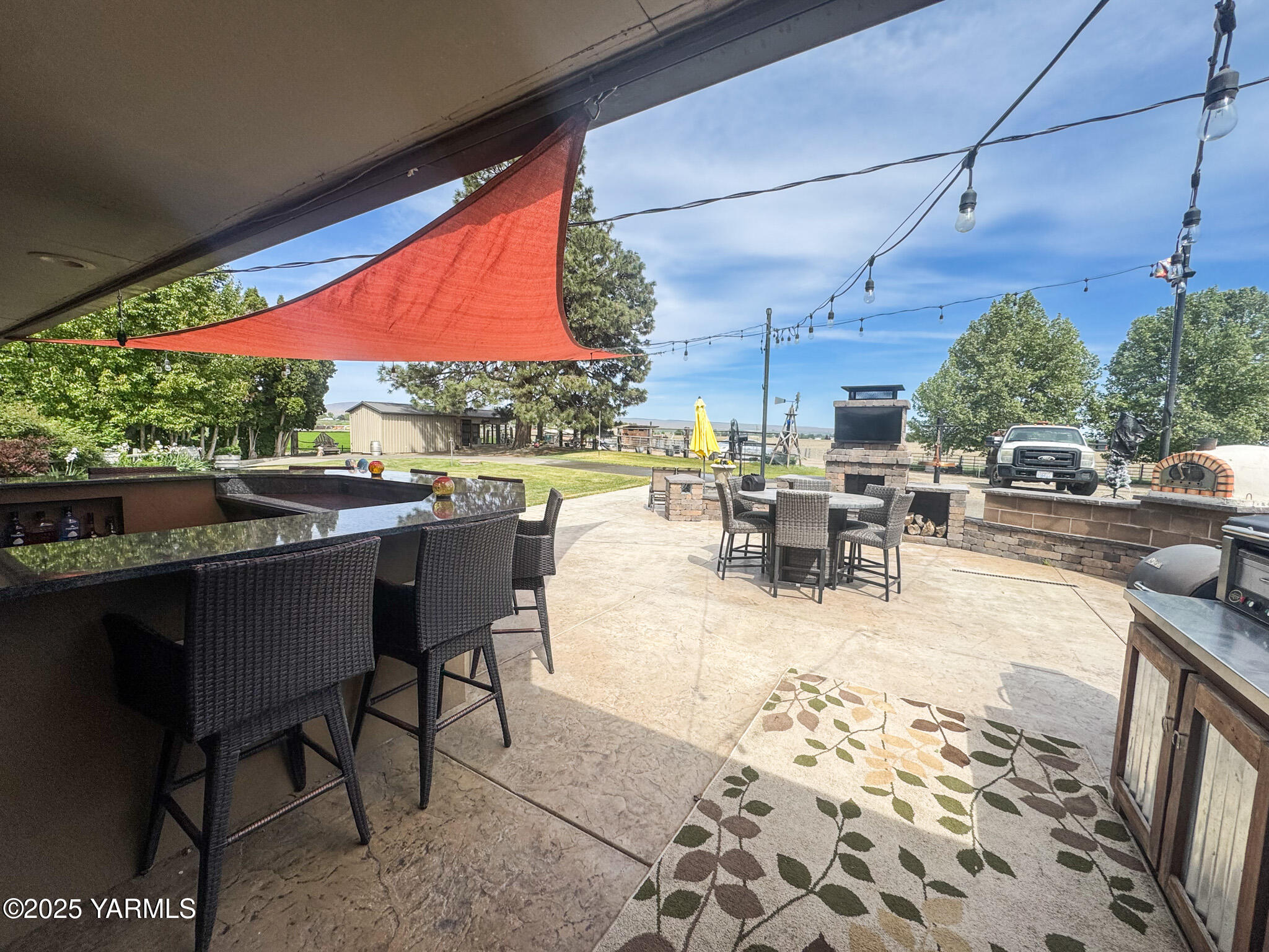 1450 Scoon Road Sunnyside, WA 98944 - Photo 27 of 33 a view of a patio with a dining table and chairs with wooden floor