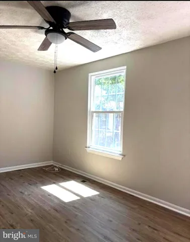 a view of a room with wooden floor closet and windows