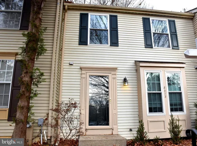 a view of a house with a window and brick walls