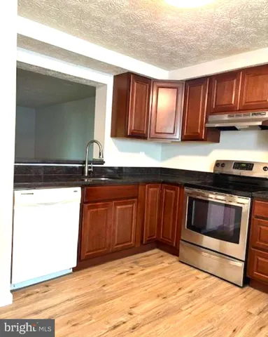 a kitchen with a sink and a stove