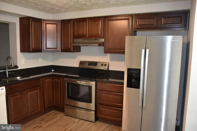 a kitchen with a sink and stainless steel appliances