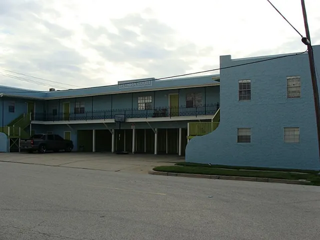 a front view of building with yard