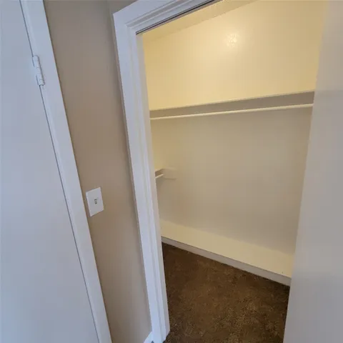 a view of closet with wooden floor