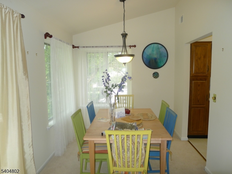 80 Sage Court Bedminster, NJ 07921 - Photo 2 of 4 a view of a dining room with furniture a chandelier and wooden floor