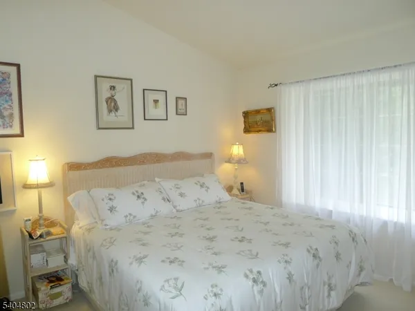 a bedroom with a bed and a lamp