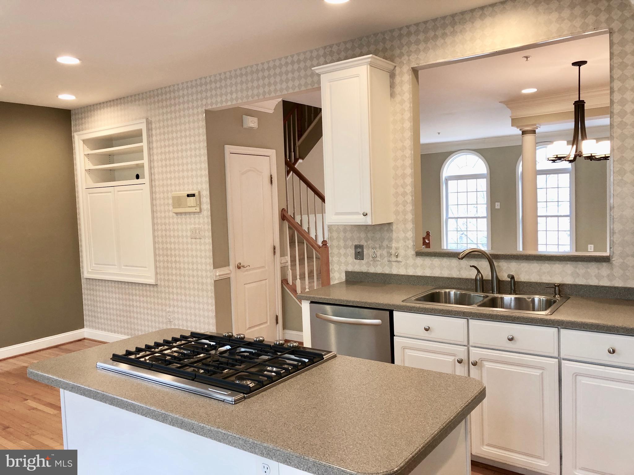 6402 Spring View Place Rockville, MD 20852 - Photo 11 of 25 a kitchen with stainless steel appliances a stove a sink and a refrigerator