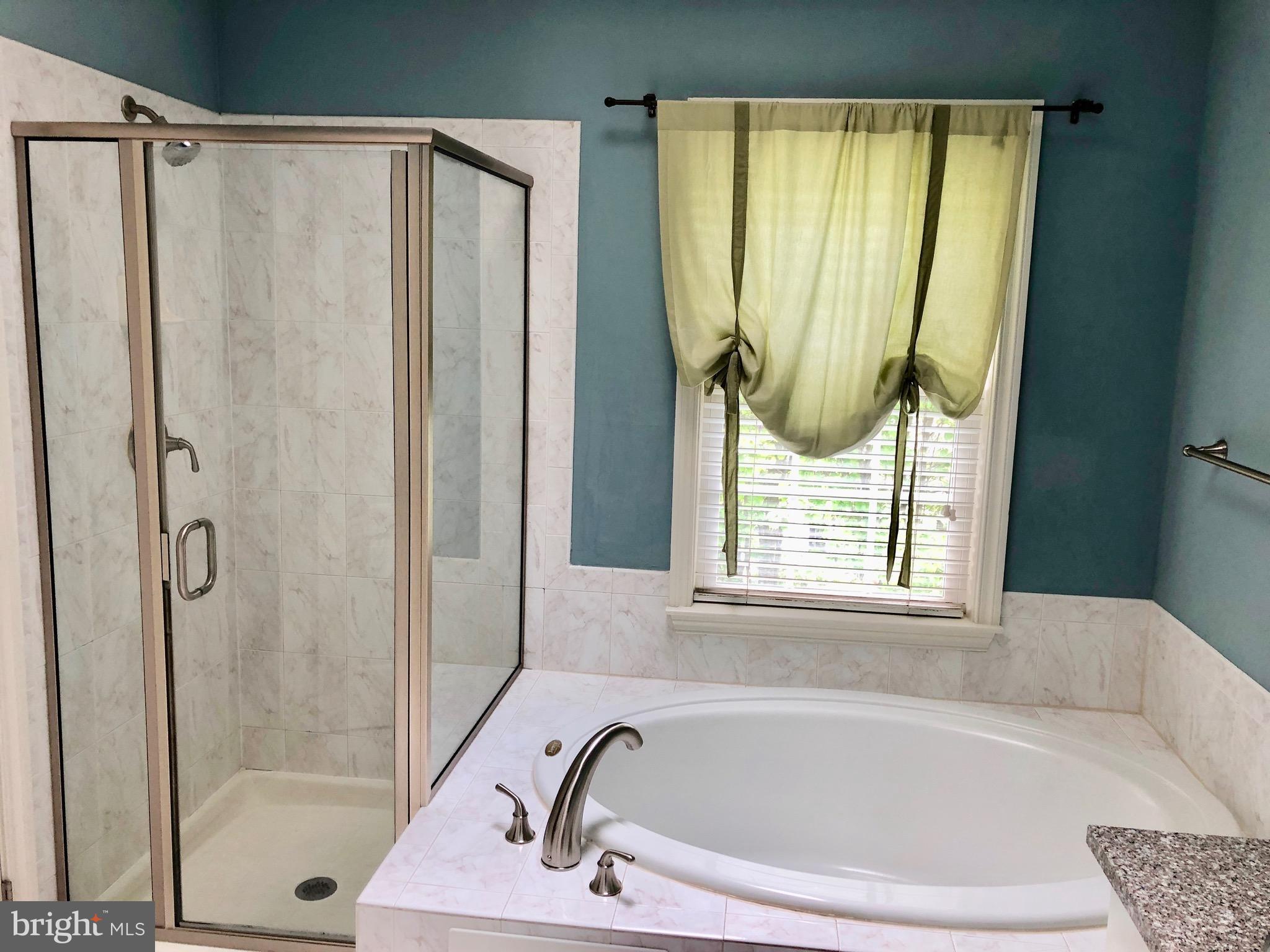 6402 Spring View Place Rockville, MD 20852 - Photo 17 of 25 a bathroom with a bathtub and a shower