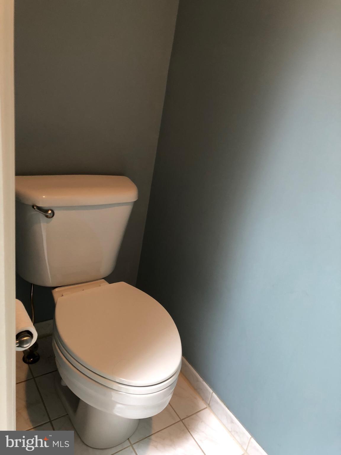 6402 Spring View Place Rockville, MD 20852 - Photo 18 of 25 a white toilet sitting next to a white wall