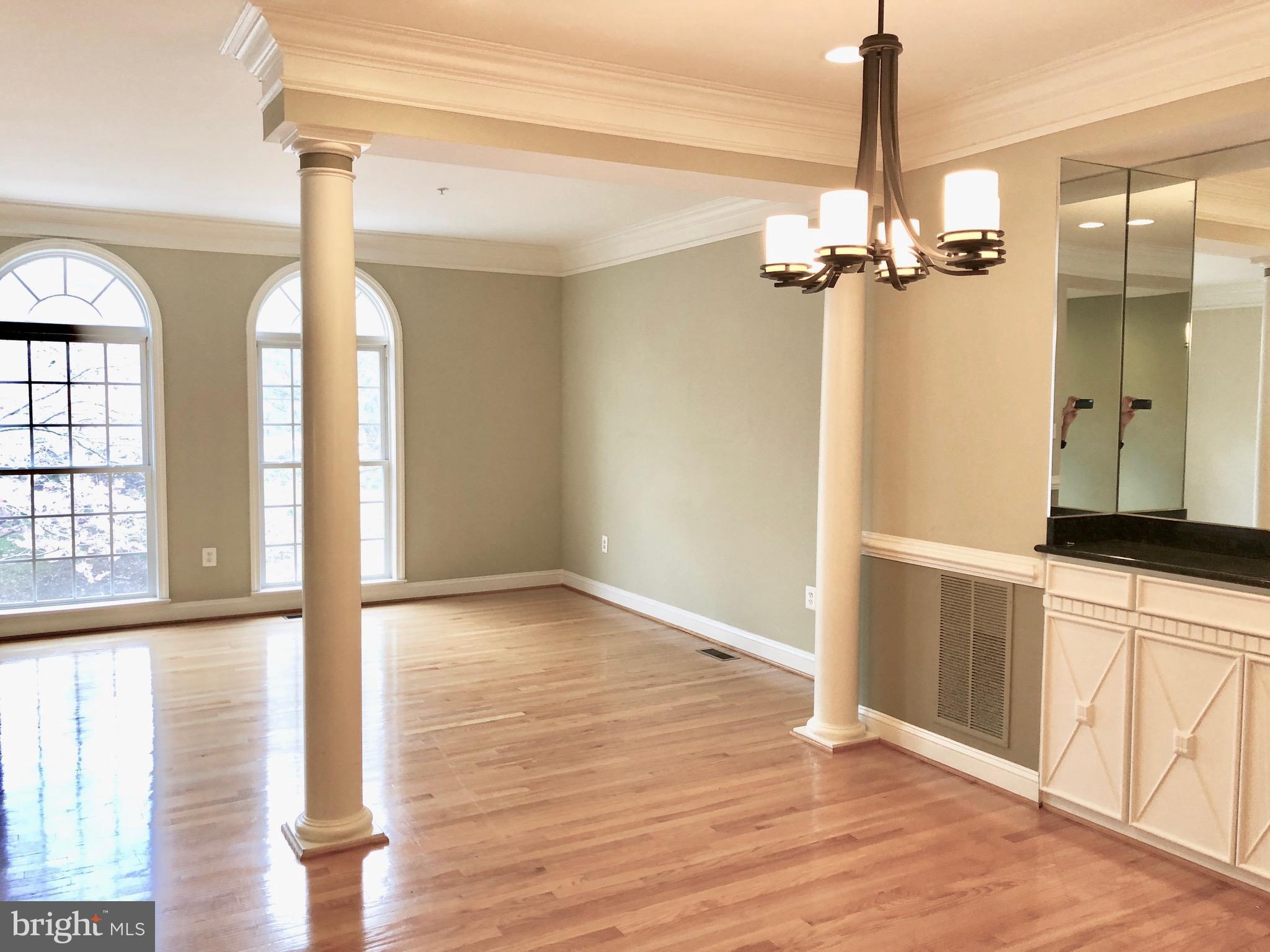 6402 Spring View Place Rockville, MD 20852 - Photo 3 of 25 a view of empty room with wooden floor and fan