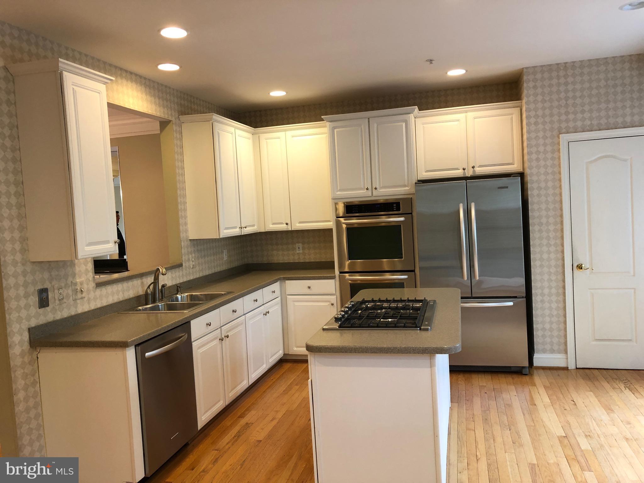 6402 Spring View Place Rockville, MD 20852 - Photo 10 of 25 a kitchen with stainless steel appliances granite countertop a stove a sink and a refrigerator