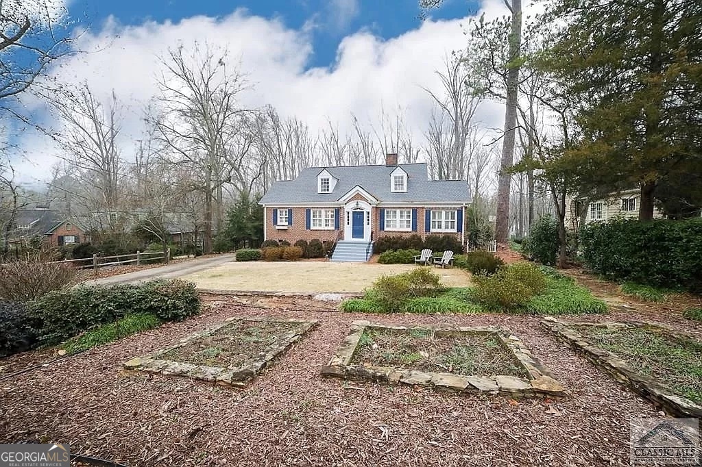 482 Highland Avenue Athens, GA 30606 - Photo 2 of 24 a front view of a house with a yard and large trees