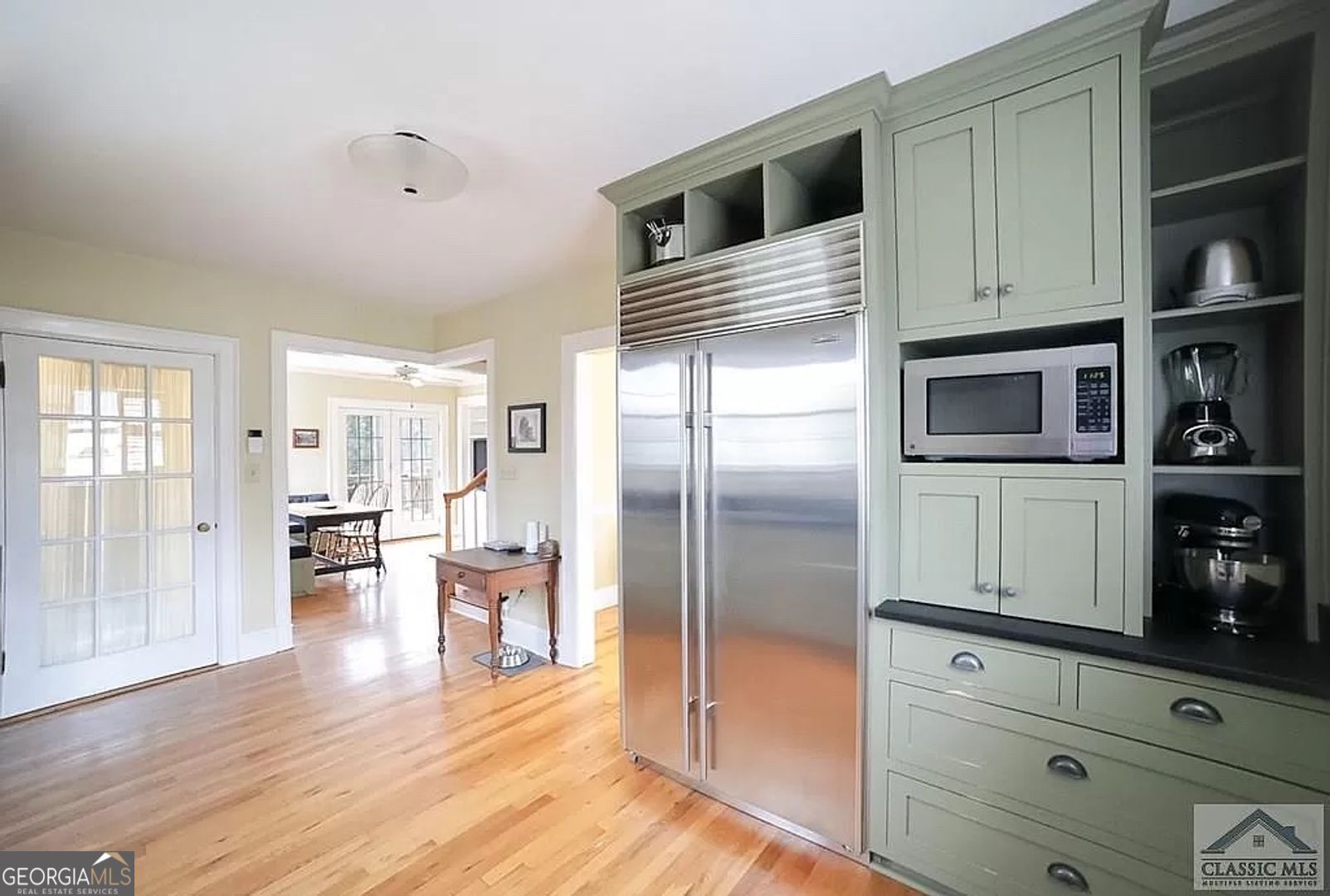 482 Highland Avenue Athens, GA 30606 - Photo 5 of 24 a kitchen with stainless steel appliances kitchen island granite countertop a refrigerator and cabinets