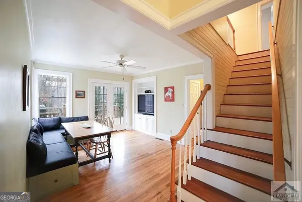 a living room with furniture and wooden floor