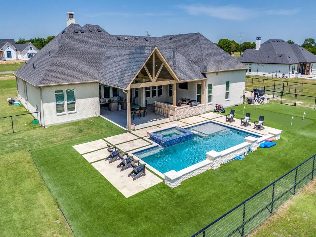 a aerial view of a house with swimming pool garden and patio
