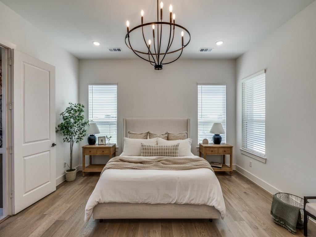 1956 Jc Maples Road Gunter, TX 75058 - Photo 17 of 38 a bedroom with a large bed and a chandelier
