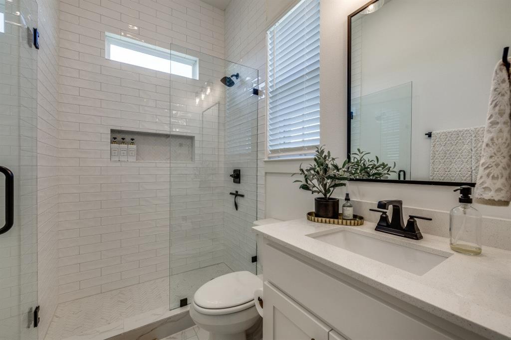 1956 Jc Maples Road Gunter, TX 75058 - Photo 24 of 38 a bathroom with a sink a toilet a shower and a mirror