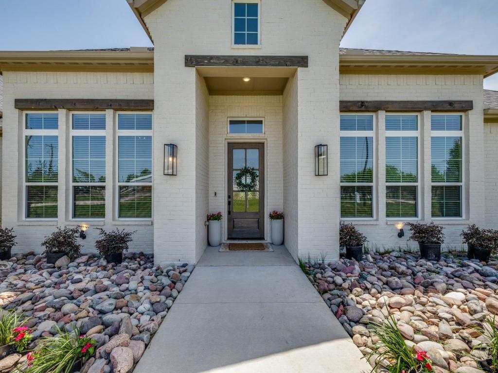 1956 Jc Maples Road Gunter, TX 75058 - Photo 3 of 38 a front view of a house with a large window and a rug