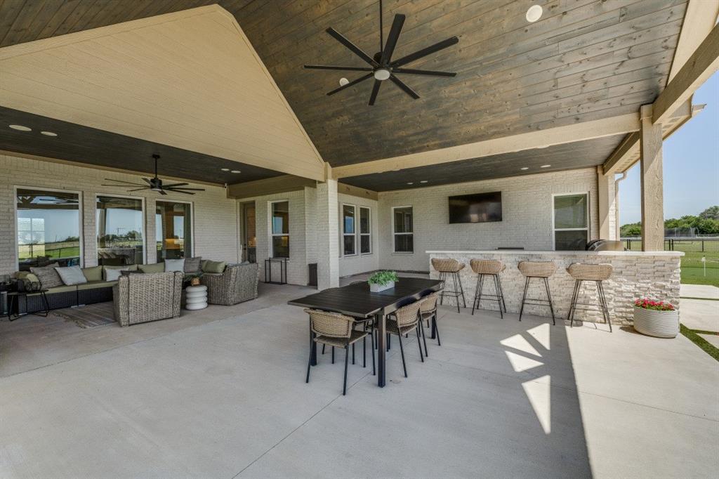 1956 Jc Maples Road Gunter, TX 75058 - Photo 34 of 38 a outdoor space with lots of tables a garden view and a couch