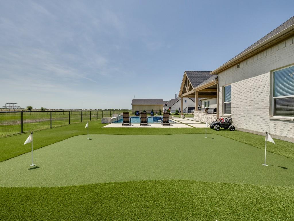 1956 Jc Maples Road Gunter, TX 75058 - Photo 38 of 38 a view of swimming pool with outdoor seating and a garden