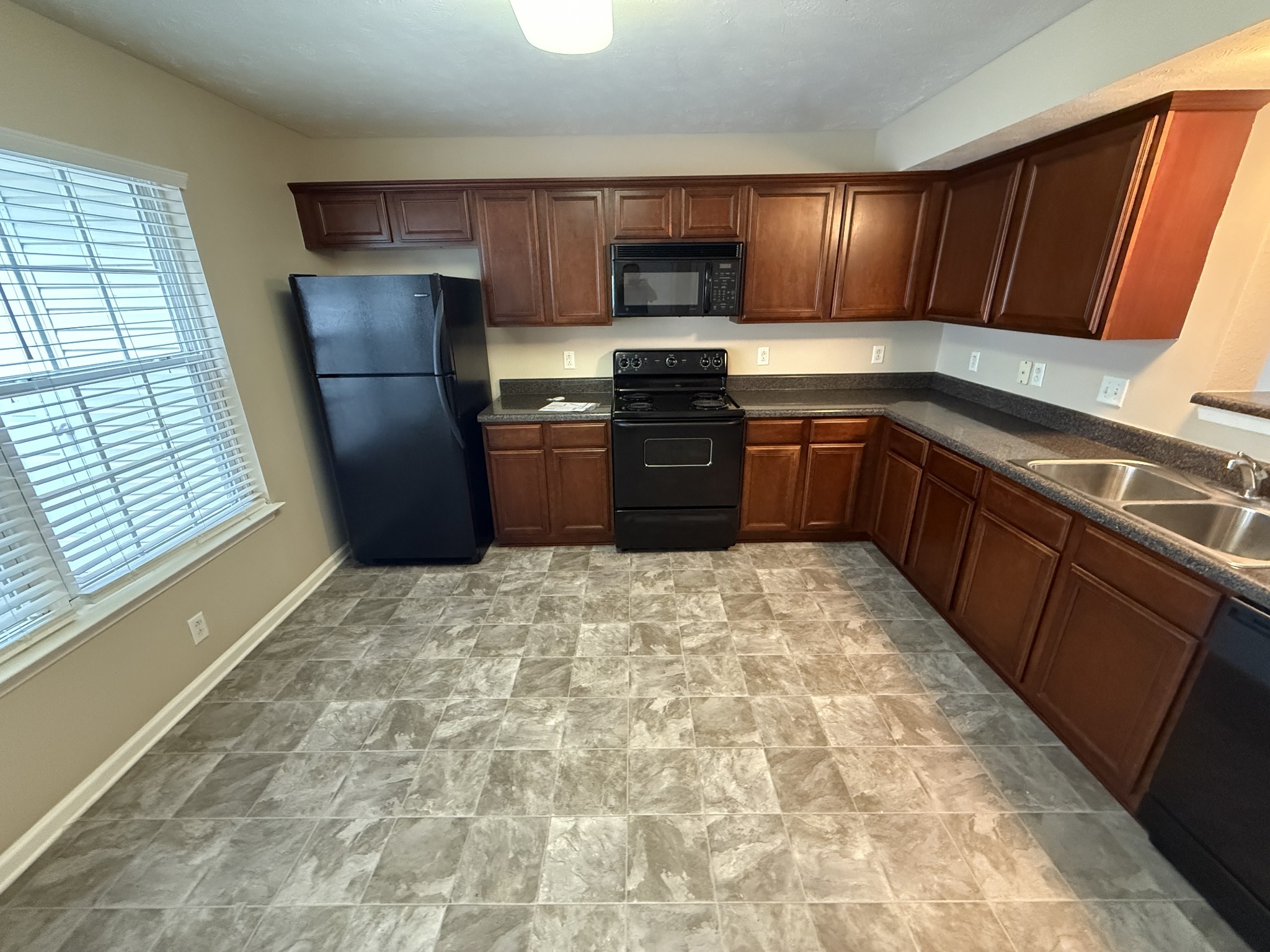 3055 London View Murfreesboro, TN 37128 - Photo 4 of 12 a kitchen with granite countertop wooden cabinets a stove top oven a sink and dishwasher
