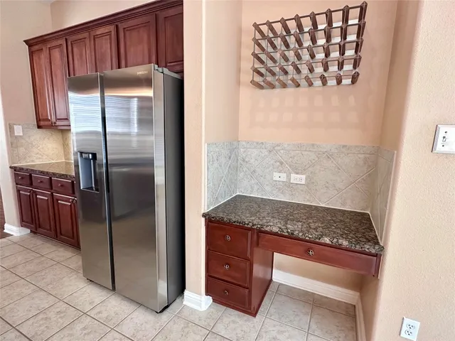 a kitchen with stainless steel appliances granite countertop a refrigerator and a sink