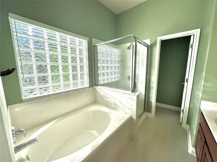 a spacious bathroom with a tub and shower