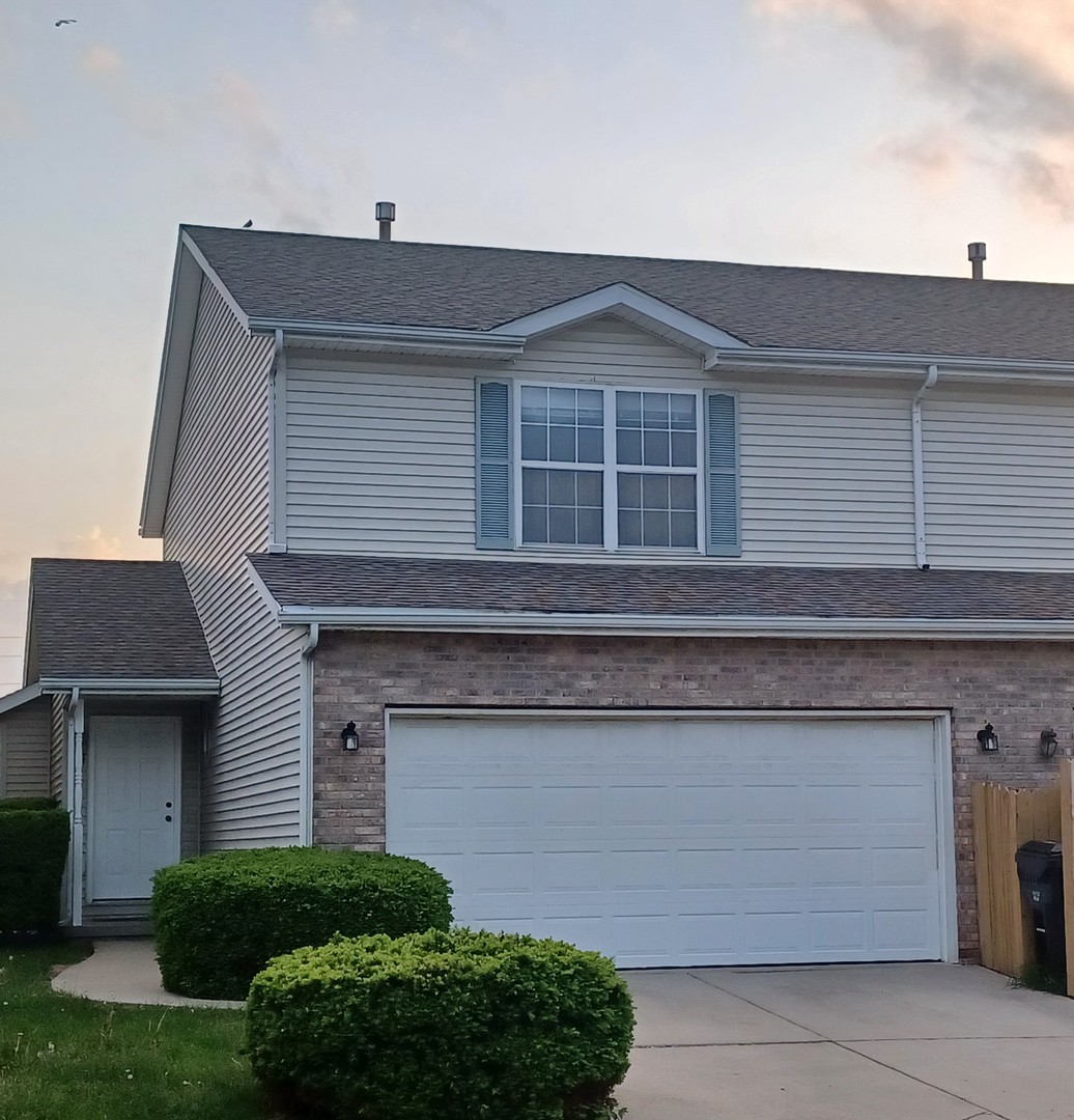 26 Vermont Avenue Bloomington, IL 61701 - Photo 1 of 15 a front view of a house with a yard and garage