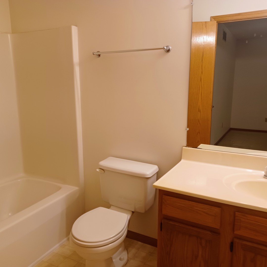 26 Vermont Avenue Bloomington, IL 61701 - Photo 10 of 15 a white toilet sitting next to a bath tub