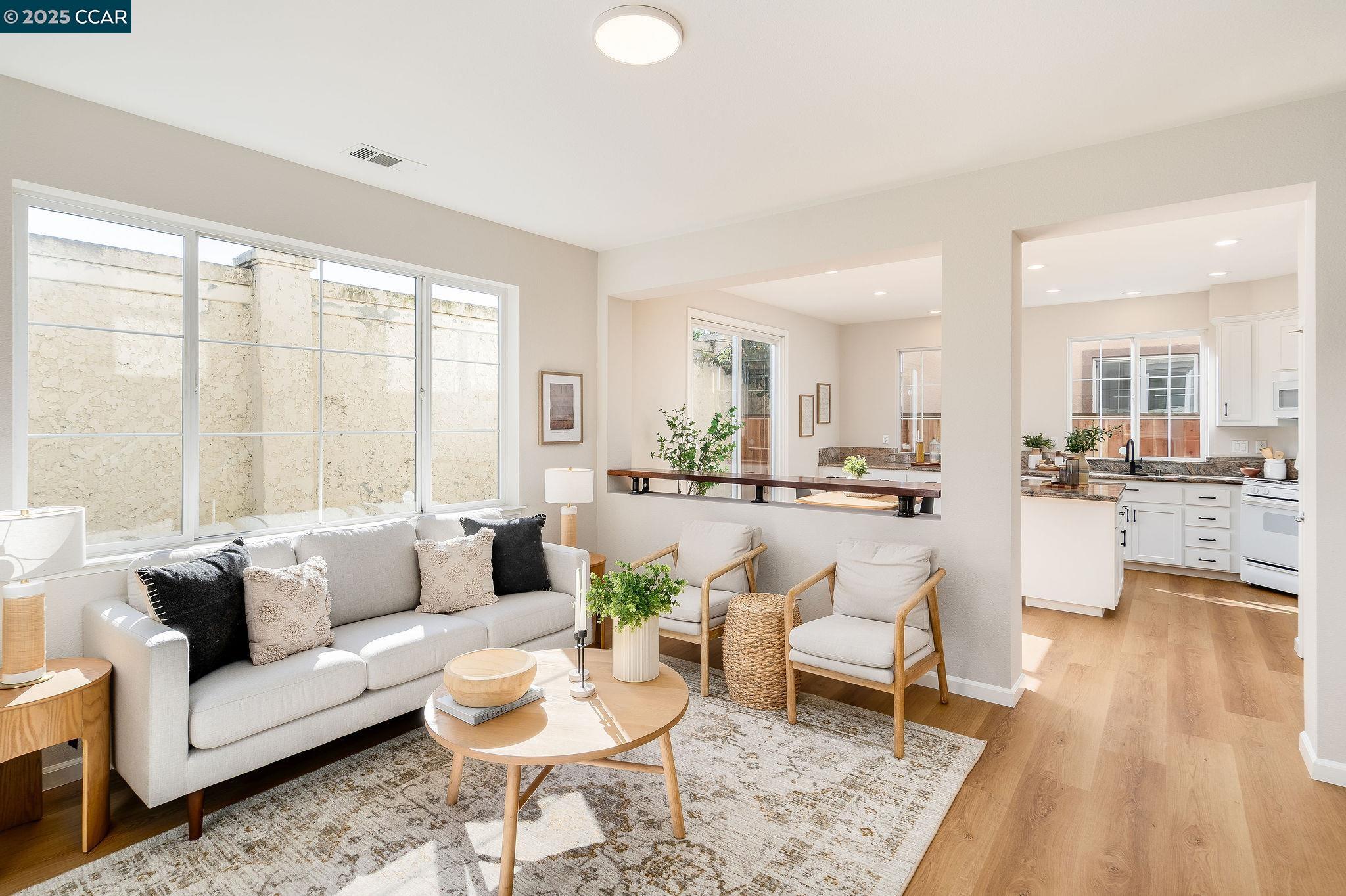 a living room with furniture and a large window