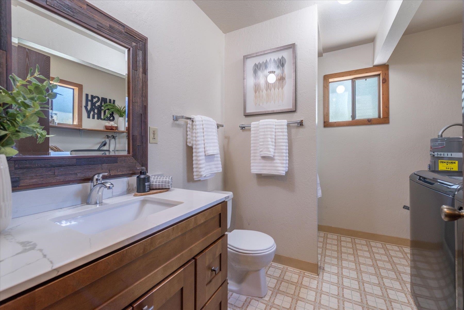 325 North Ridge Road Carnelian Bay, CA 96140 - Photo 20 of 22 a bathroom with a sink a toilet and mirror