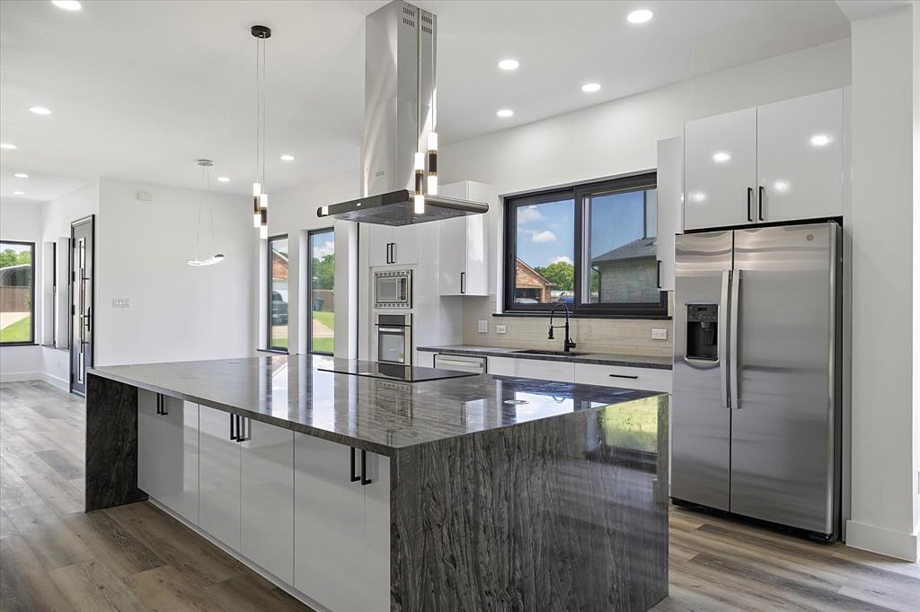 2811 Rodeo Drive Quinlan, TX 75474 - Photo 5 of 35 Kitchen featuring appliances with stainless steel finishes, island range hood, modern cabinets, white cabinets, and recessed lighting