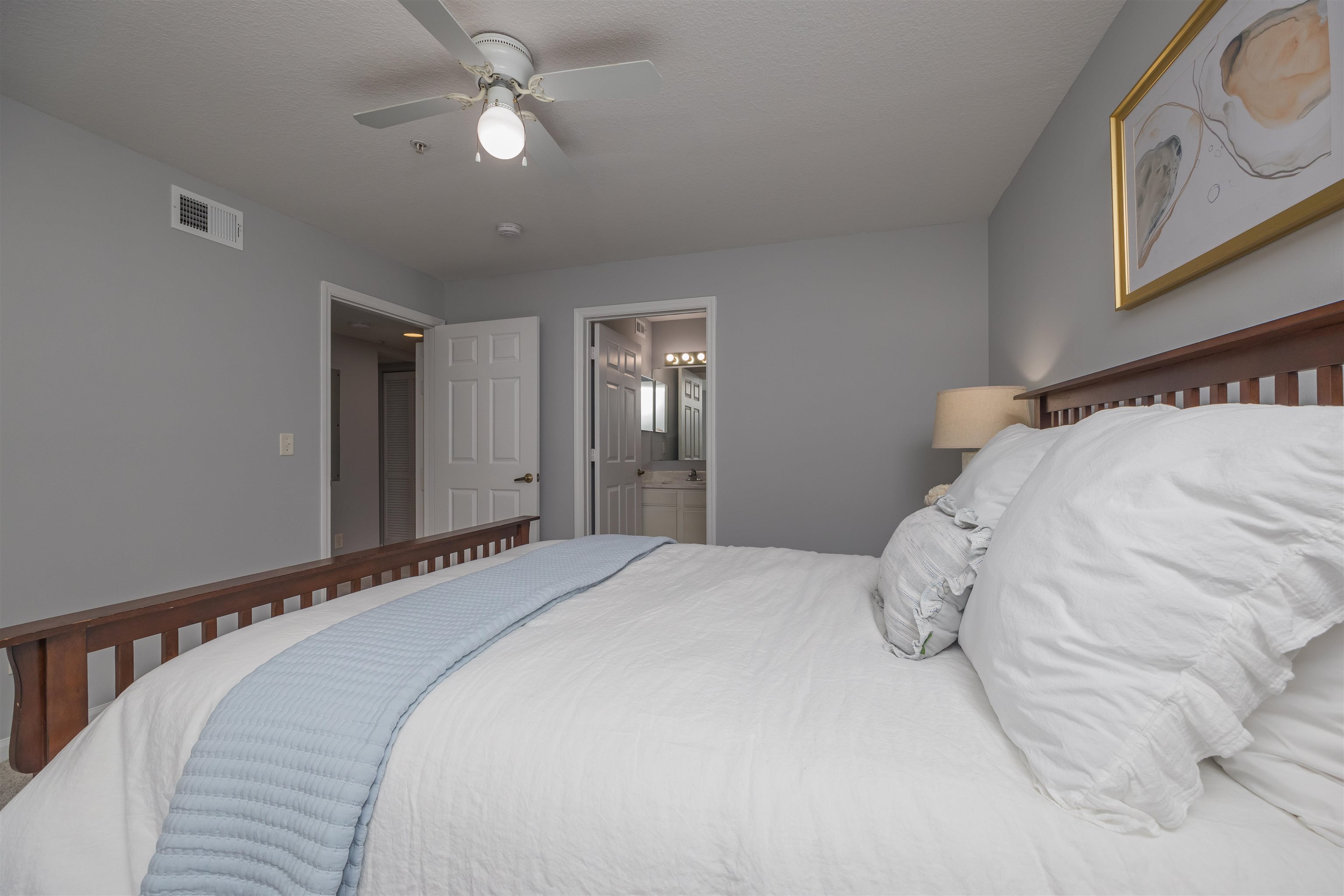 208 16th Street, Unit B St. Augustine, FL 32080 - Photo 22 of 68 a bedroom with a large bed and a chandelier